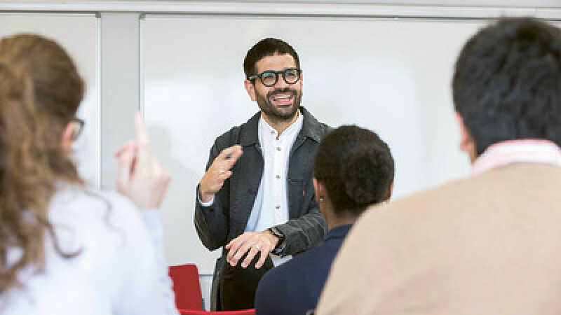 Academic staff member giving a lecture to adults