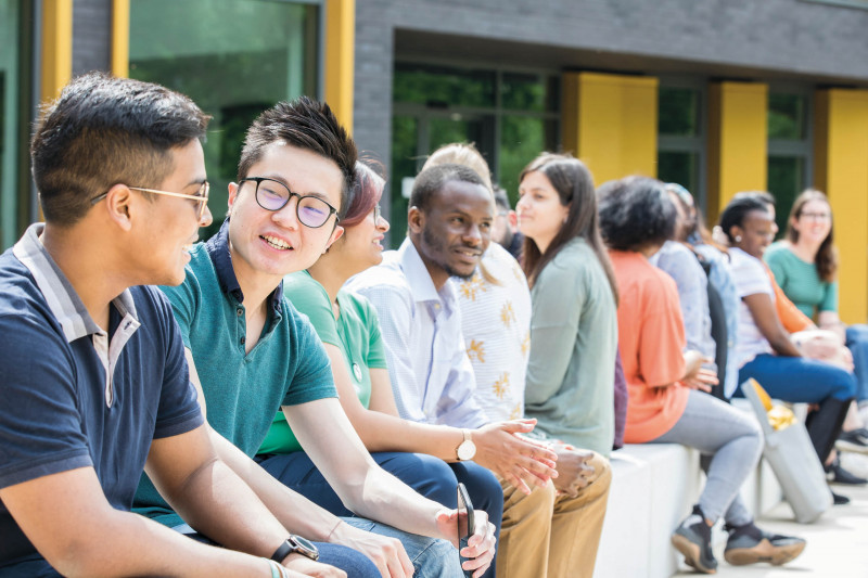 Students sitting outside chatting