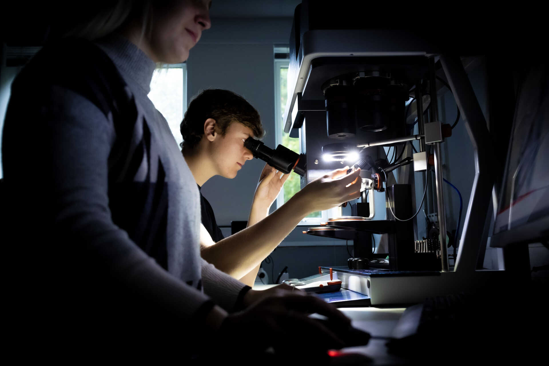 A man looking into a microscope