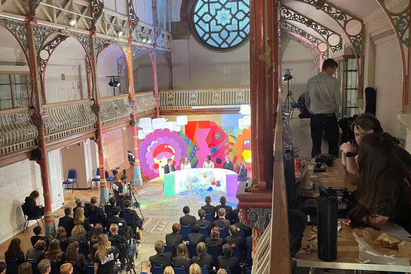 The Generation Genome panel presents to a student audience in a church